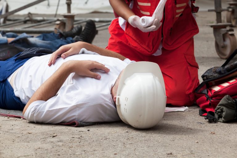 man being attended to by paramedic