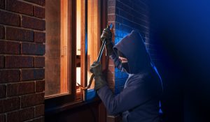 thief breaking a window