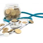 A stethoscope wrapped around a jar overflowing with coins