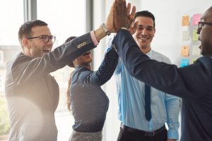 team of employees high fivev