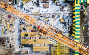 a big construction site with cranes and other heavy machinery