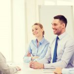 A confident woman in front of professionals during a job interview feeling confident