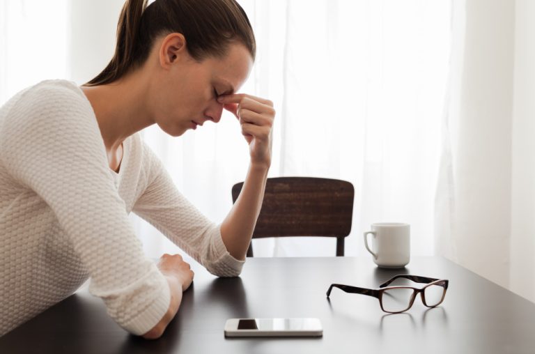 Young female employee feeling stressed while at work.