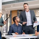smiling businessman shaking hands with a female business owner