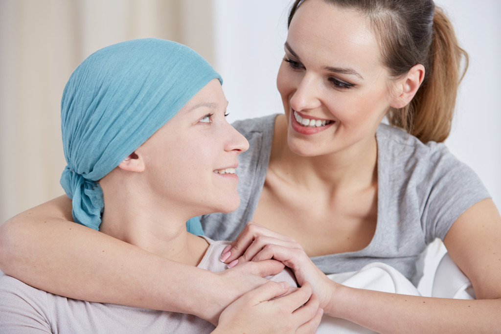woman hugging a cancer patient from behind