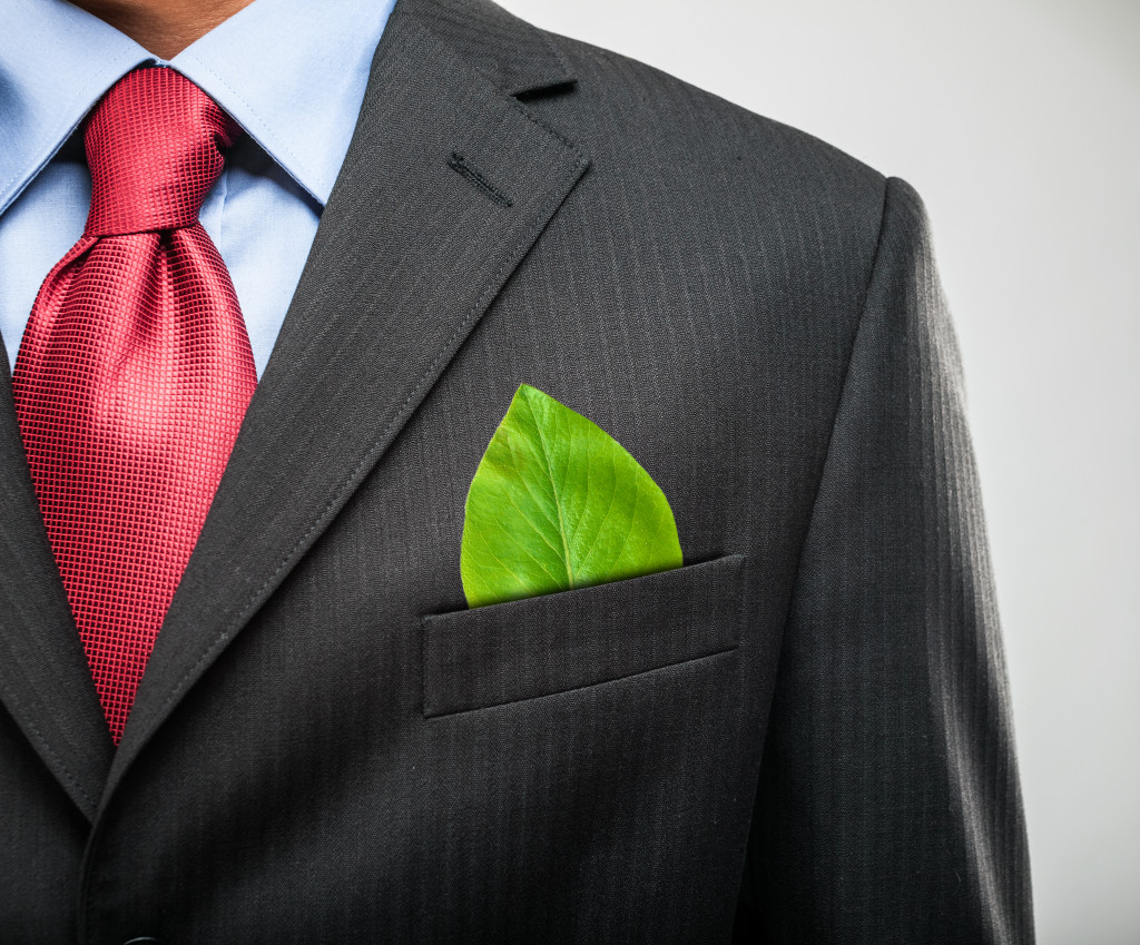 a man wearing suit with a leaf on the pocket