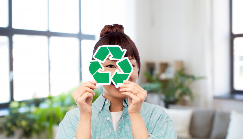 woman holding eco-friendly logo or symbol